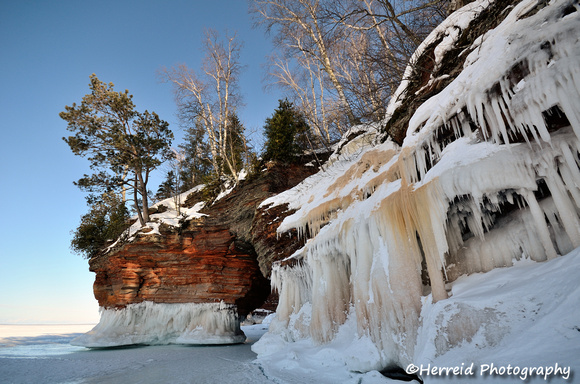 Arch and Icy Sandstone Cliffs